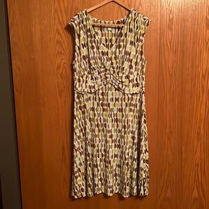 Dress Barn brown, green and blue print dress with a white background.